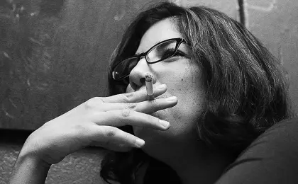 pensive woman smoking a cigarette