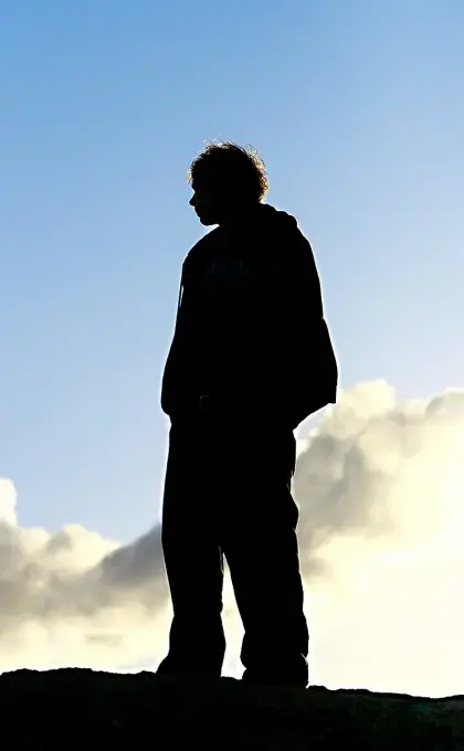 silhouette of a man standing on a mountain