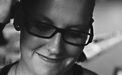 woman with content smile, looking down